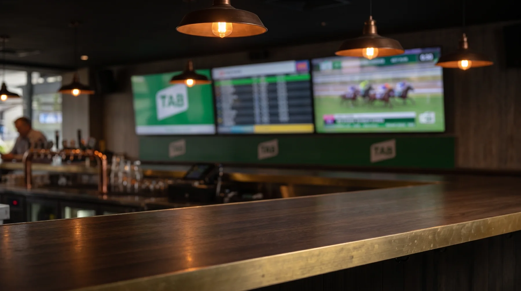 A pub bar top with TAB race screens glowing in the background.